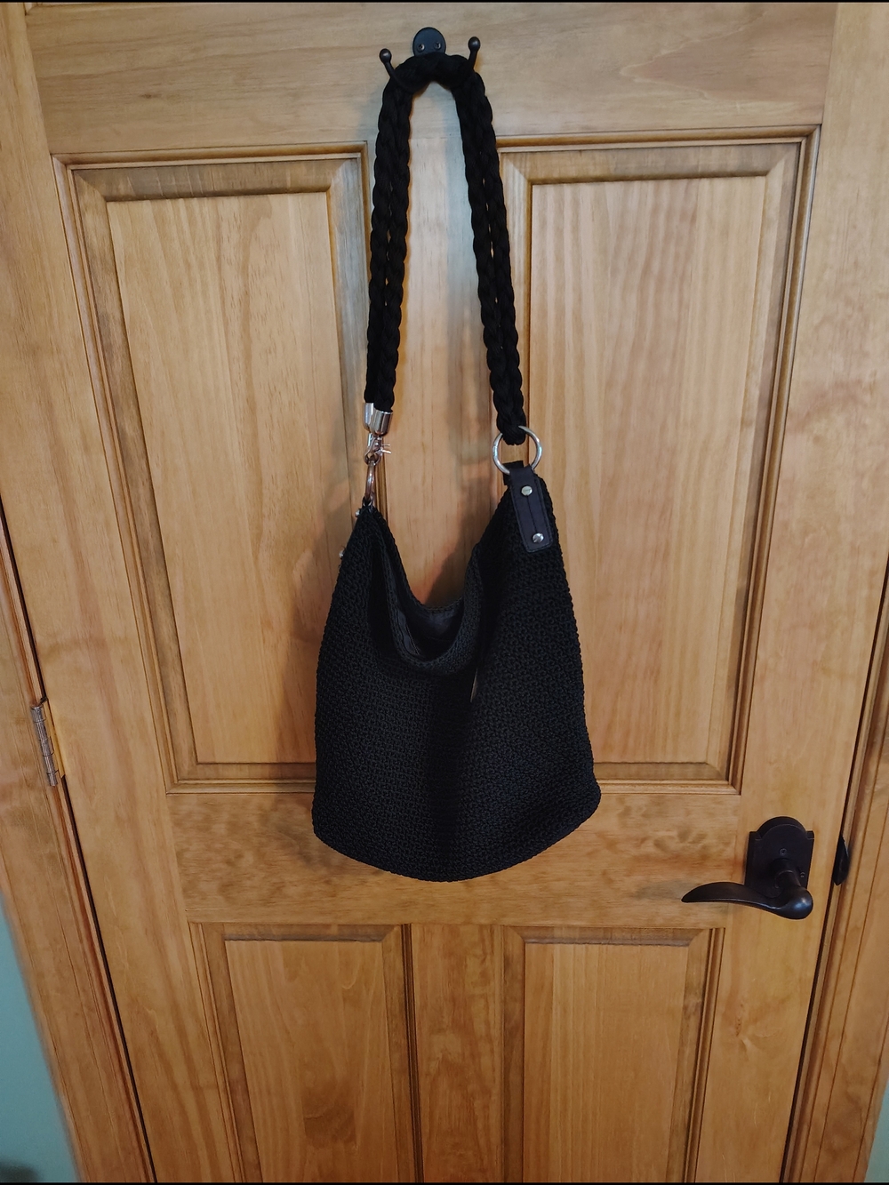 The Sak Black Crochet Shoulder Bag with Braided Strap and Ring Accents